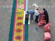 On Good Friday, an alfombra is constructed out of sawdust on the church plaza