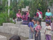 We just finished unloading blocks off a truck, and the Mayans are eager to help move them to their final destinations