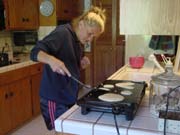 Kelly prepares pancakes for breakfast