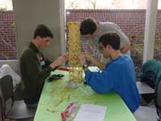 Daniel, Tony, and Michael working on a spaghetti tower